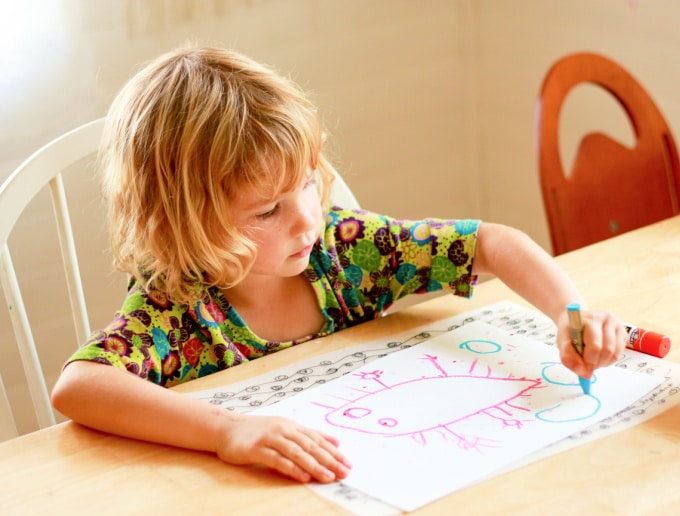 Child drawing dinosaur